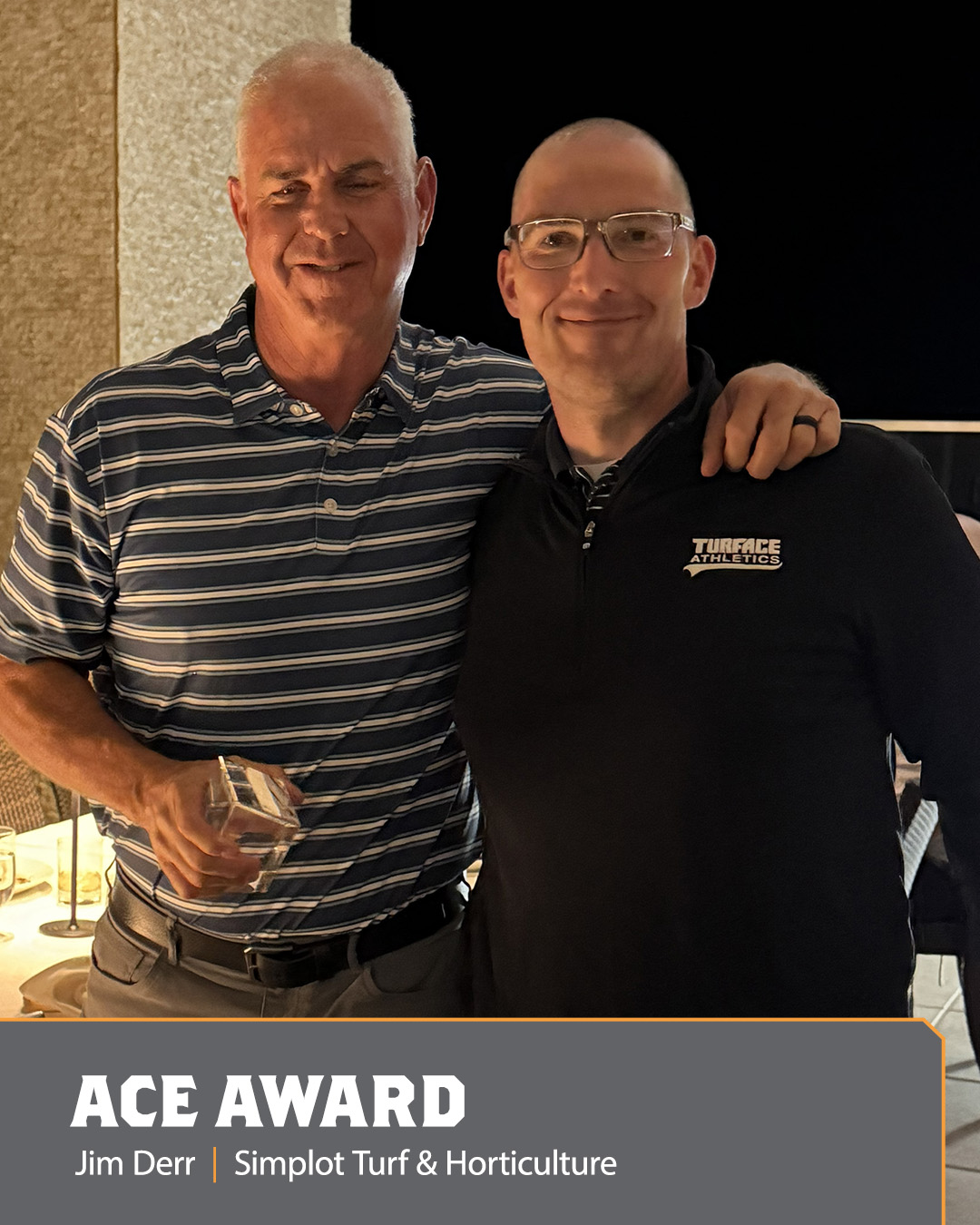 Image of two men holding an Ace Award.
