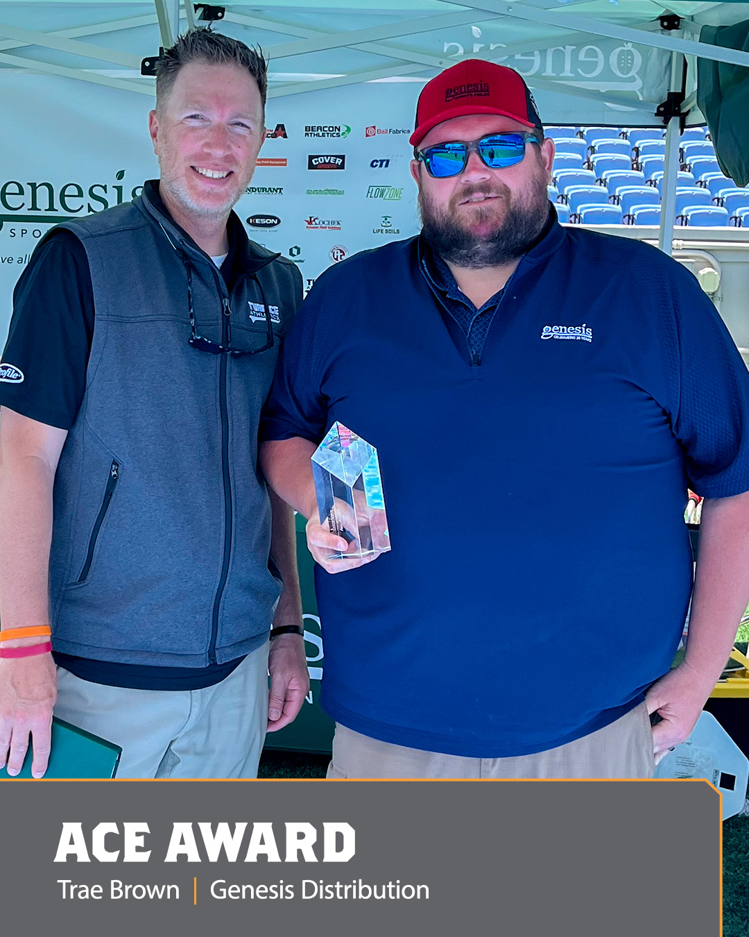 Image of two men holding an Ace Award.
