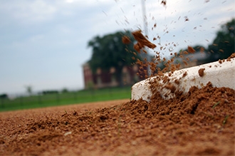 Dirt being kicked up by a pitching mound.