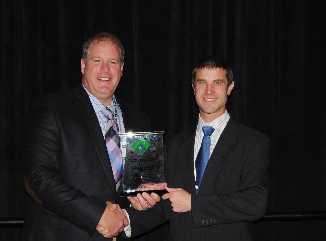 John Sarna, left, of Hampshire High School, accepts the 2013 Field Maintenance Award from Jeff Langner, brand manager for Turface Athletics™. 