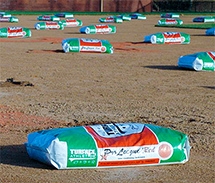 Bags of Turface products on an infield.
