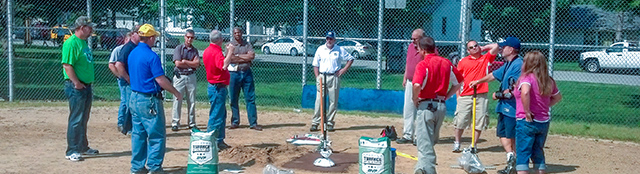 Group watching a demo of Turface around homeplate