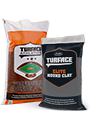 Two construction-material bags side by side: an orange-and-white bag labeled “Lime Mortar” and a black bag labeled “SURFACE FLX,” both shown against a light background.