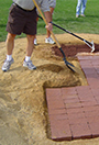 MoundMaster block being added to a baseball pitching mound.